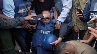 Mourners react over the body of Palestinian journalist Hassan Eslaiah, who was killed in an overnight Israeli strike on Nasser Hospital, in Khan Younis, Gaza Strip, 13.05.2025