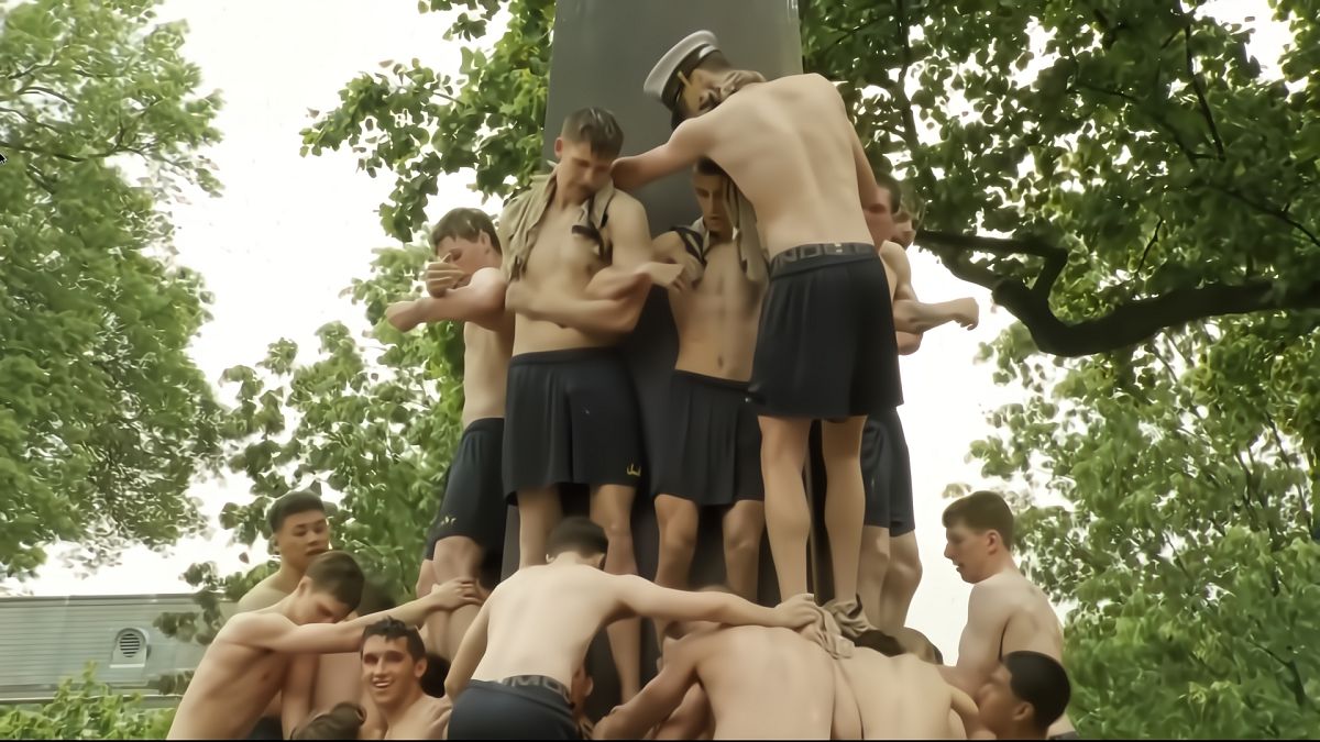 US Naval Academy students scale greased monument in annual tradition