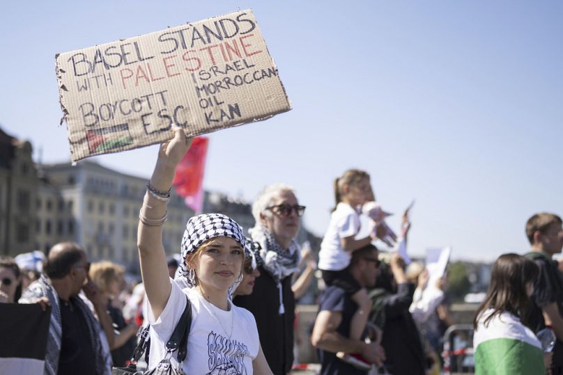 A girl holds up a Pro-Palestinian placard during the opening ceremony of the 69th Eurovision Song Contest, in Basel, Switzerland, Sunday, May 11, 2025.