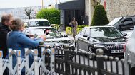 Journalists work behind a barrier as vehicles begin arriving outside a gate prior to expected talks between Russian and Ukrainian delegations at the Dolmabache palace,  May 16