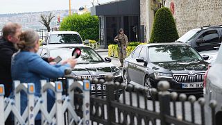 Journalists work behind a barrier as vehicles begin arriving outside a gate prior to expected talks between Russian and Ukrainian delegations at the Dolmabache palace,  May 16