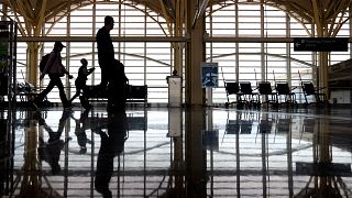 Travellers walk along a concourse at Reagan National Airport, Arlington, Virginia. 19 July 2024.