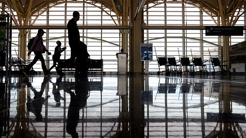 Travellers walk along a concourse at Reagan National Airport, Arlington, Virginia. 19 July 2024.