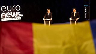Presidential candidates Nicusor Dan and George Simion gesture during a Euronews Romania electoral debate ahead of the presidential election runoff in Bucharest, 8 May 2025