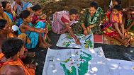 Kamala Kadria from the Gadaba Indigenous community points to a spot on a map they made in Hatipakna village, Koraput district, in India's eastern state of Odisha, April 2025.
