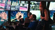 In the control room of Research Vessel Falkor (too), Chief Scientist Michelle Taylor and Scientist Tea Isler marvel at a massive coral spotted during a ROV dive.