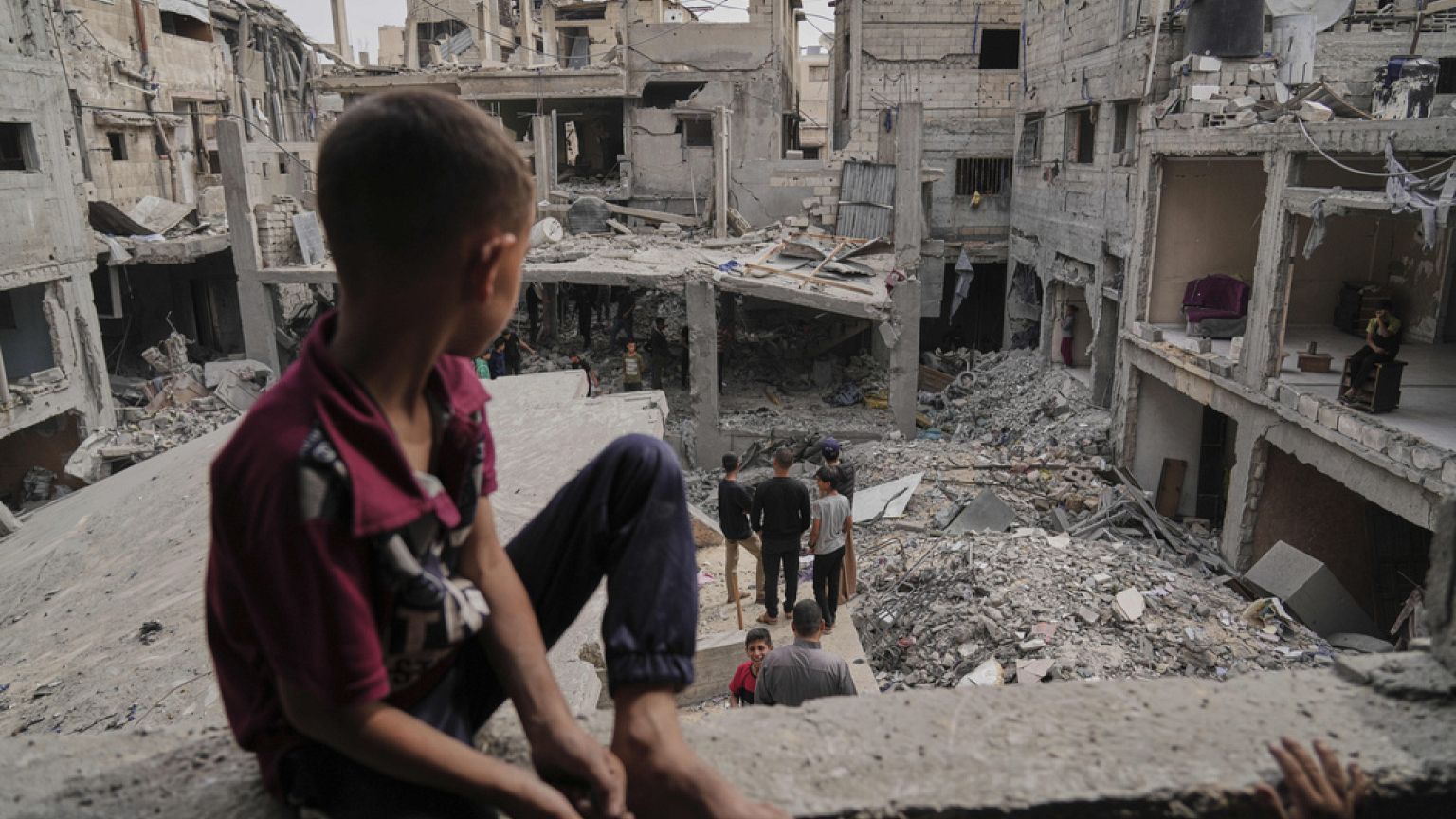 Palestinians inspect the rubble of the Al-Lahham family's home, destroyed by Israeli airstrikes in Khan Younis, Gaza Strip, on Thursday, May 15, 2025.