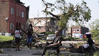 A man sits in a chair after a severe storm moved through St. Louis, Missouri, Friday, May 16, 2025.