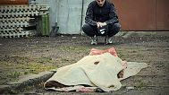 In this photo provided by the Ukrainian Emergency Service, a man reacts at the body of a killed resident following Russia's drone attack in the Kyiv region, Ukraine,18.05.2025