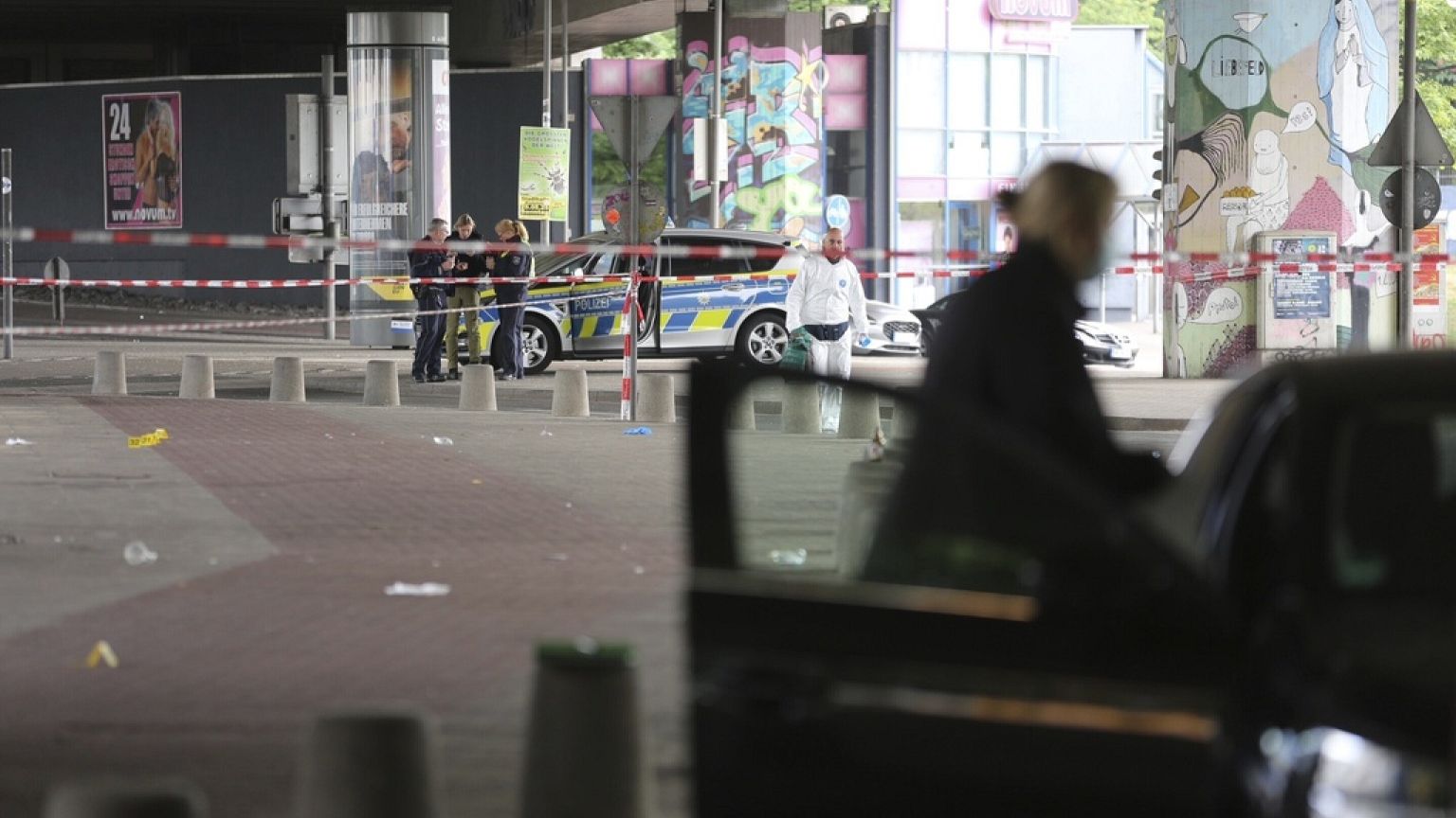Police and forensic investigators are on the scene following an attack in the western city of Bielefeld, Germany, Sunday May 18, 2025. (Christian Müller/dpa via AP)
