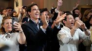 Supporters of the center-right ruling coalition of Prime Minister Luis Montenegro react to exit polls following Portugal's general election, in Lisbon, 18 May 2025