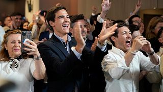 Supporters of the center-right ruling coalition of Prime Minister Luis Montenegro react to exit polls following Portugal's general election, in Lisbon, 18 May 2025