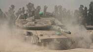 Israeli soldiers move tanks around staging area near the border with the Gaza Strip, in southern Israel, Sunday, May 18, 2025.