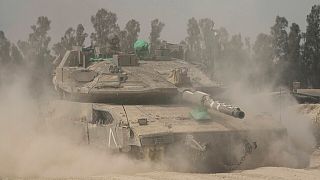 Israeli soldiers move tanks around staging area near the border with the Gaza Strip, in southern Israel, Sunday, May 18, 2025.