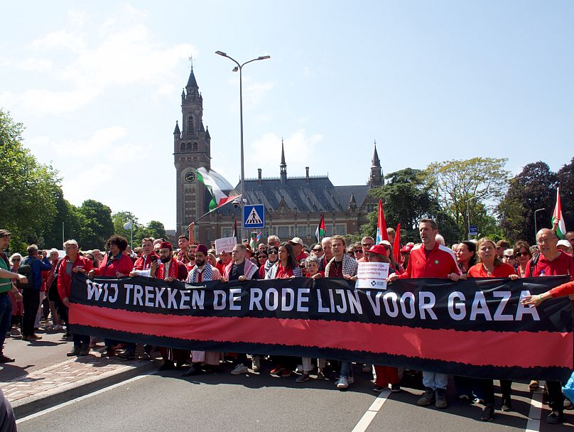 Protesters carry a banner that reads We trekken een rode lijn voor Gaza (We draw a red line for Gaza) during the Red Line protest in The Hague, Netherlands on 18 May, 2025.