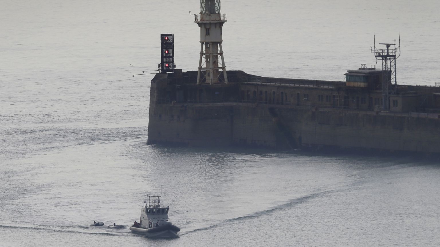 A Border Force vessel brings a group of people thought to be migrants into the port city of Dover, England, on 8 August, 2020. A Border Force vessel brings a group of people thought to be migrants into the port city of Dover, England, on 8 August, 2020.