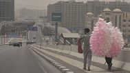 FILE: Cotton candy vendors walk during a dusty weather, before expected sandstorm, in Cairo, 30 April 2025