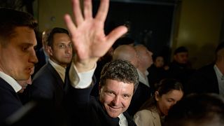Presidential candidate Nicusor Dan waves to supporters after winning the second round of the country's presidential election redo in Bucharest, 19 May 2025