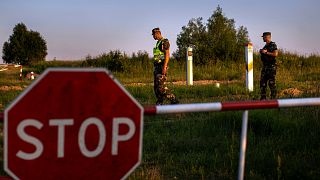 FILE - Members of the Lithuania State Border Guard Service patrol on the border with Belarus, near the village of Purvenai, Lithuania, 9 July 2021.