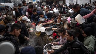 Palestinians line up for a meal in Rafah, 21 December, 2023