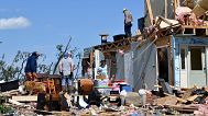 Family members cull through the debris of their home destroyed by a severe storm in London, Ky., Saturday, May 17, 2025. 