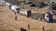 Trucks carrying humanitarian aid enter the Gaza Strip from Egypt in the southern town of Rafah, 12 February, 2025