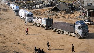 Trucks carrying humanitarian aid enter the Gaza Strip from Egypt in the southern town of Rafah, 12 February, 2025