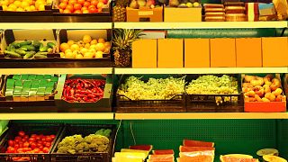 Rows of fruits and vegetables at a supermarket