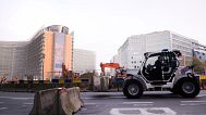 FILE PHOTO - Police use a tractor to move roadblocks around the European Union quarter ahead of a farmers demonstration in Brussels, Wednesday, Nov. 13, 2024.