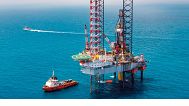 An offshore oil drilling platform in the middle of the ocean.
