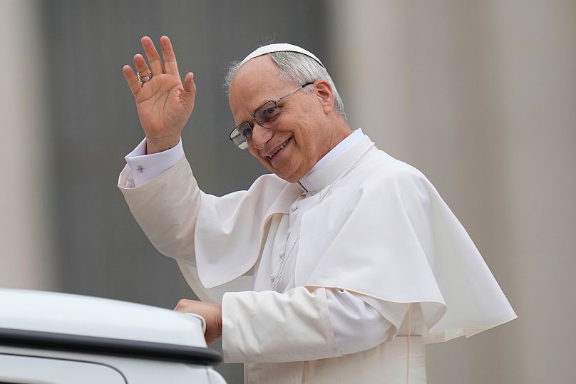 Pope Leo XIV waves as he arrives for his first weekly general audience in St Peter's Square at The Vatican, 21 May, 2025