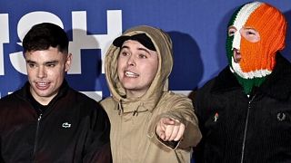 Kneecap member Liam Óg Ó hAnnaidh - centre - charged with a terror offense in the UK