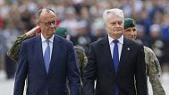 Lithuania's President Gitanas Nauseda, right, and German Chancellor Friedrich Merz, Vilnius, Lithuania, Thursday, May 22, 2025. (AP Photo/Mindaugas Kulbis).