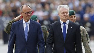 Lithuania's President Gitanas Nauseda, right, and German Chancellor Friedrich Merz, Vilnius, Lithuania, Thursday, May 22, 2025. (AP Photo/Mindaugas Kulbis).