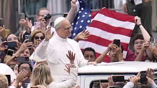 Pope Leo XIV waves as he arrives for his first weekly general audience in St. Peter's Square at The Vatican, Wednesday, May 21, 2025
