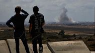 People watch smoke rising to the sky after an explosion in the Gaza Strip as they visit a sightseeing area in Sderot, southern Israel, Thursday, May 22, 2025