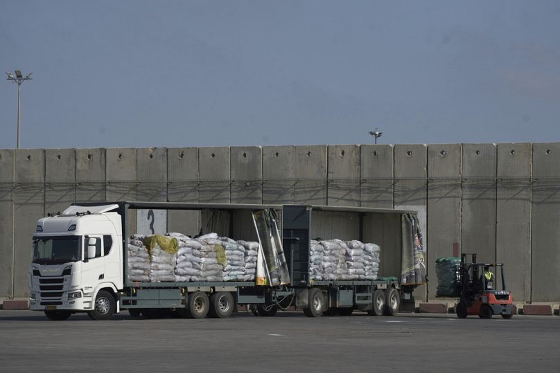 A worker unloads cargo from a truck carrying humanitarian aid for the Gaza Strip at the offload area of the Kerem Shalom border crossing between Israel and Gaza, May 22, 2025