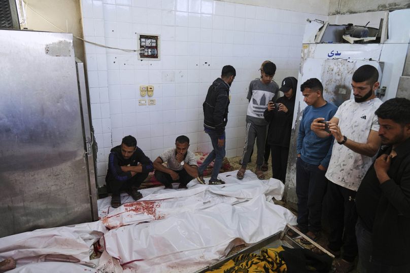 Palestinian mourn their relatives who were killed in an Israeli army airstrike on the Gaza Strip, at the morgue of Al-Aqsa Hospital in Deir al-Balah, Thursday, May 22, 2025