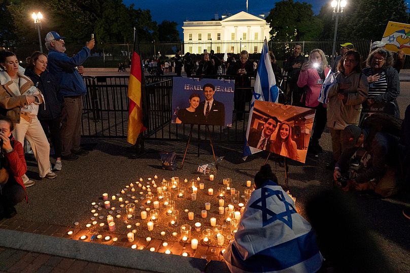 People light candles at a memorial for Yaron Lischinsky and Sarah Milgrim outside the White House in Washington, 22 May, 2025