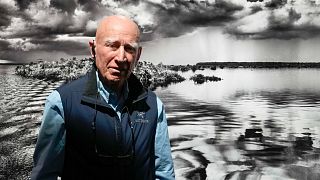 Brazilian photographer Sebastião Salgado poses at one of his exhibitions in Milan, 19 November, 2023