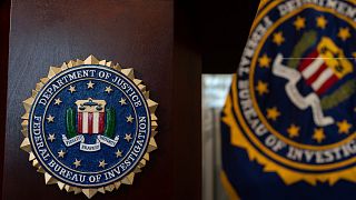 An FBI seal is displayed on a podium before a news conference at the field office in Portland, 16 January, 2025