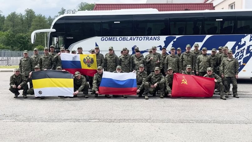 Russian servicemen pose after returning from captivity after an exchange between Russia and Ukraine, at an undisclosed location in Belarus, Saturday, May 24, 2025.