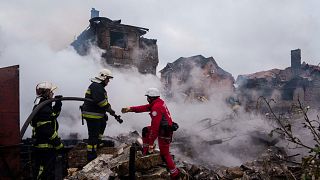Rescue workers extinguish a fire of a house destroyed by a Russian strike in Markhalivka village, Kyiv region, Ukraine, Sunday, May 25, 2025. (AP Photo/Evgeniy Maloletka)