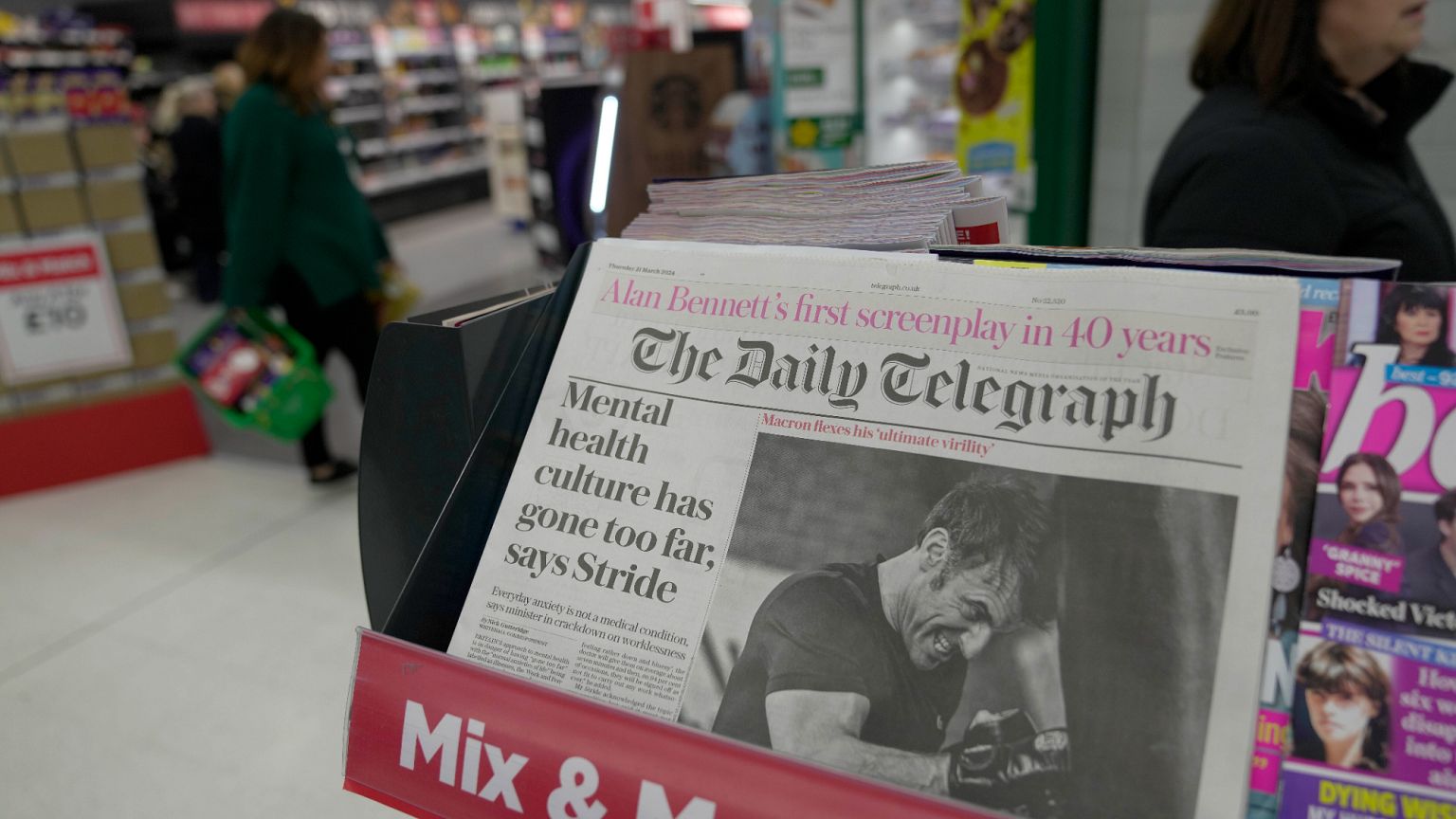 The Daily Telegraph newspaper with the front page of French President Emanuel Macron is seen at a supermarket in London, March 21, 2024. 