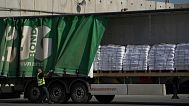 FILE - A worker unloads cargo from a truck carrying humanitarian aid for the Gaza Strip, Thursday, May 22, 2025. 