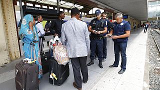 French police officers check identity documents at the Saint-Charles train station, in Marseille.
