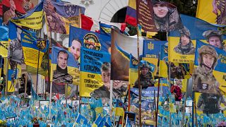 Flags with portraits of soldiers wave at a makeshift memorial for fallen Ukrainian soldiers, on Independence Square in Kyiv, Ukraine, Friday, Jan. 17, 2025.