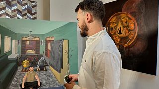 Andrei Kozlov, who was taken hostage by Hamas during the 7 October 2023, attack on Israel, looks at his painting, “One God,” Andrei Kozlov, who was taken hostage by Hamas during the 7 October 2023, attack on Israel, looks at his painting, “One God,”