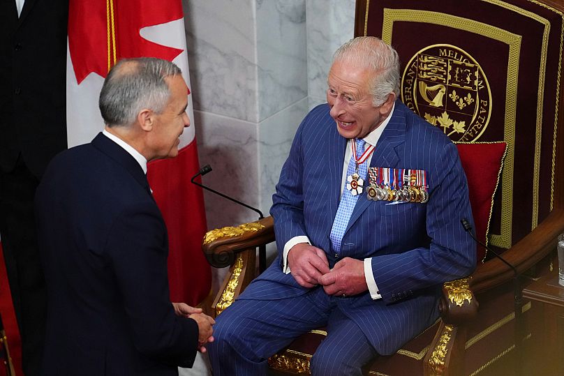 Canada Prime Minister Mark Carney, left, and King Charles talk ahead of the King delivering speech from the throne in the Senate in Ottawa, Canada on Tuesday, May 27, 2025.