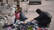 Islam Abu Taeima, una madre de cinco hijos de 40 años, y su hija Waed de 9 años buscan comida en un montón de basura en la Ciudad de Gaza, el domingo 25 de mayo de 2025